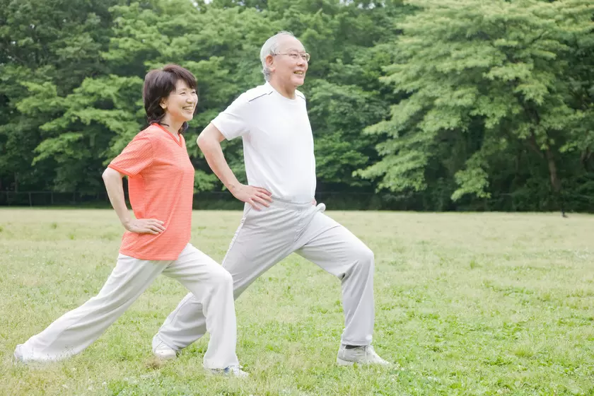 Mobility exercises for seniors: A senior practices seated hamstring stretches to improve leg flexibility.