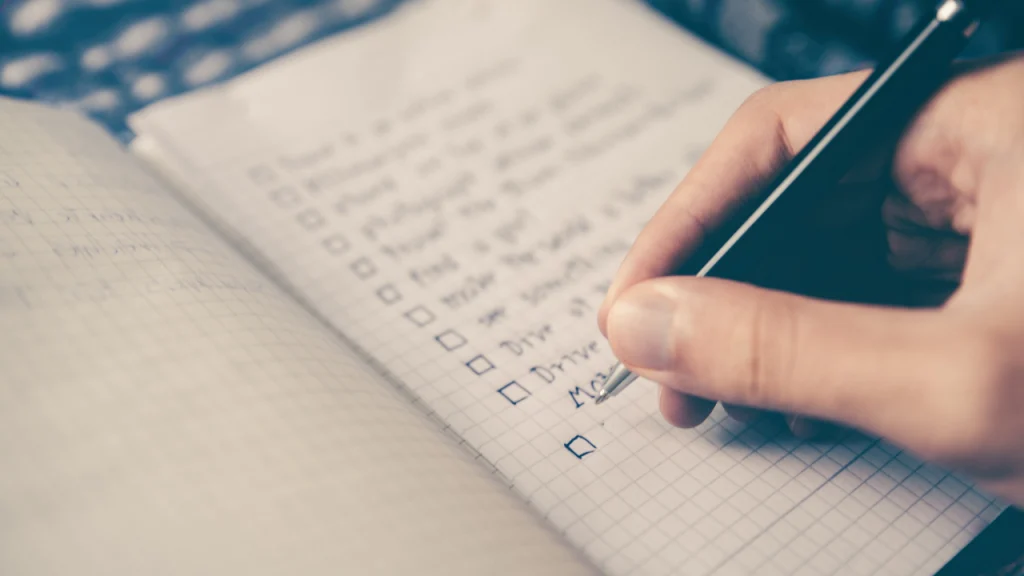 A man writing down smart goals for diet